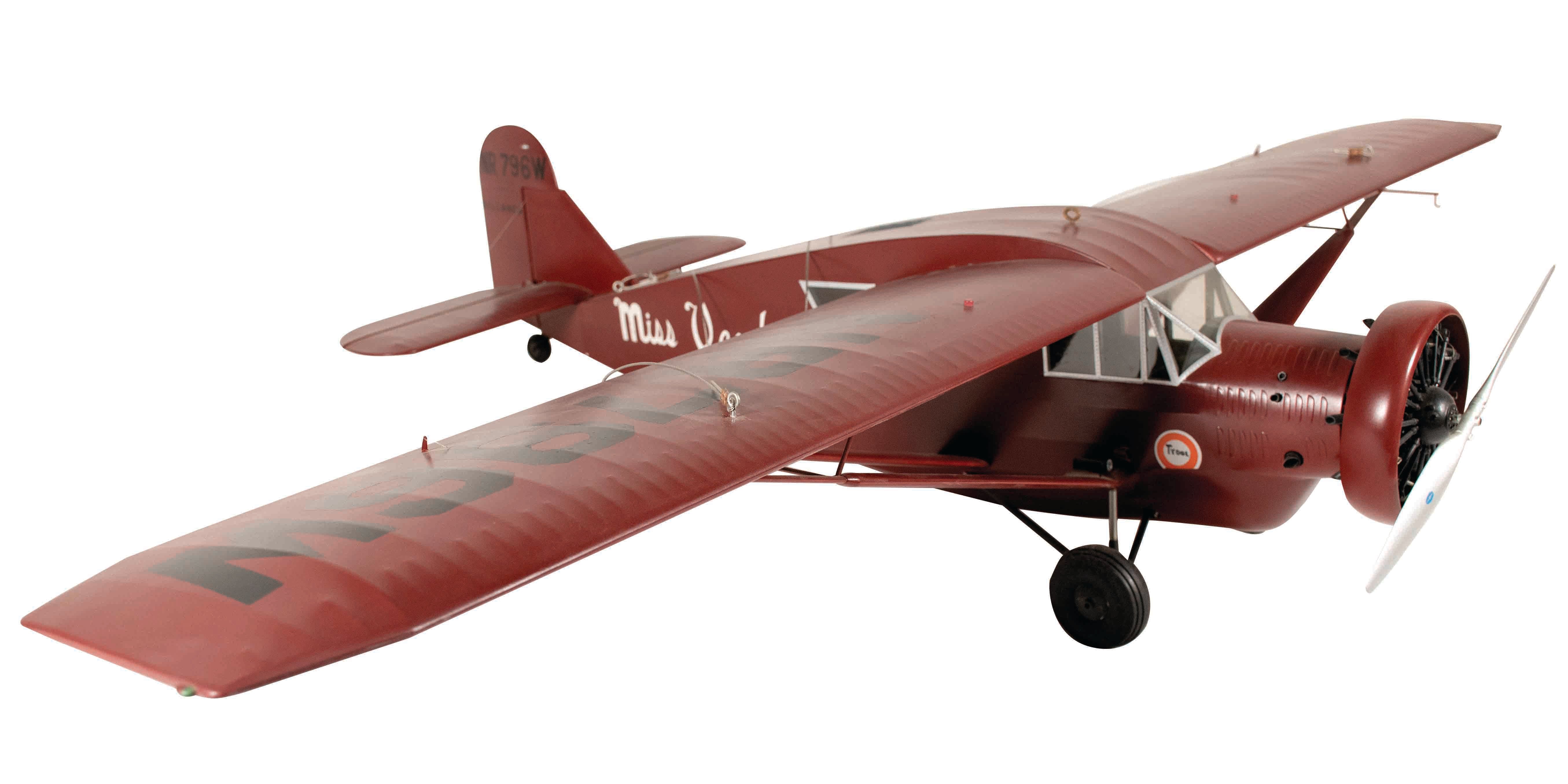 A model of Bellanca J-300 "Miss Veedol," a plane painted red with an elongated nose, somewhat resembling a pig's snout.