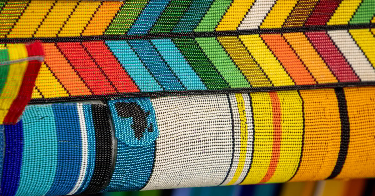 Featured image: Detail of The MiG-21 Project, a fully beaded MiG-21 fighter jet. Detail includes closeup of beadwork demonstrating the plane's vibrant patterns and a small beaded detail in the shape of the African continent. - Read full post: Beads of Resistance